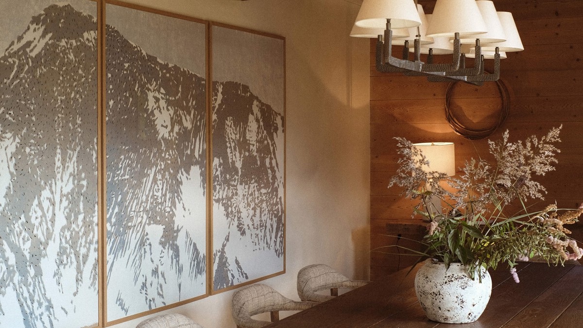 A clicked photo shows a dining area with a flower vase and unique art portrait.