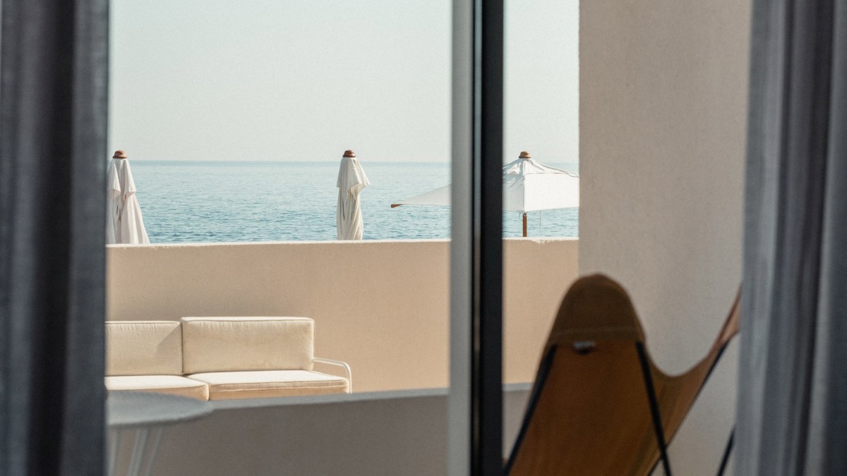 A photo captures a hanging lamp positioned beside the cozy bed.