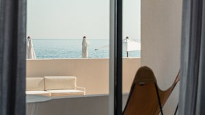 A photo captures a hanging lamp positioned beside the cozy bed.