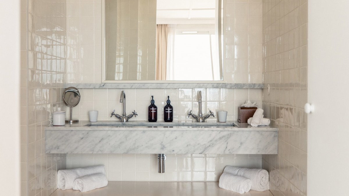 A photo captures a bathroom with bathing essentials neatly arranged and properly organized throughout.