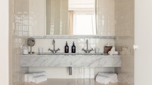 A photo captures a bathroom with bathing essentials neatly arranged and properly organized throughout.