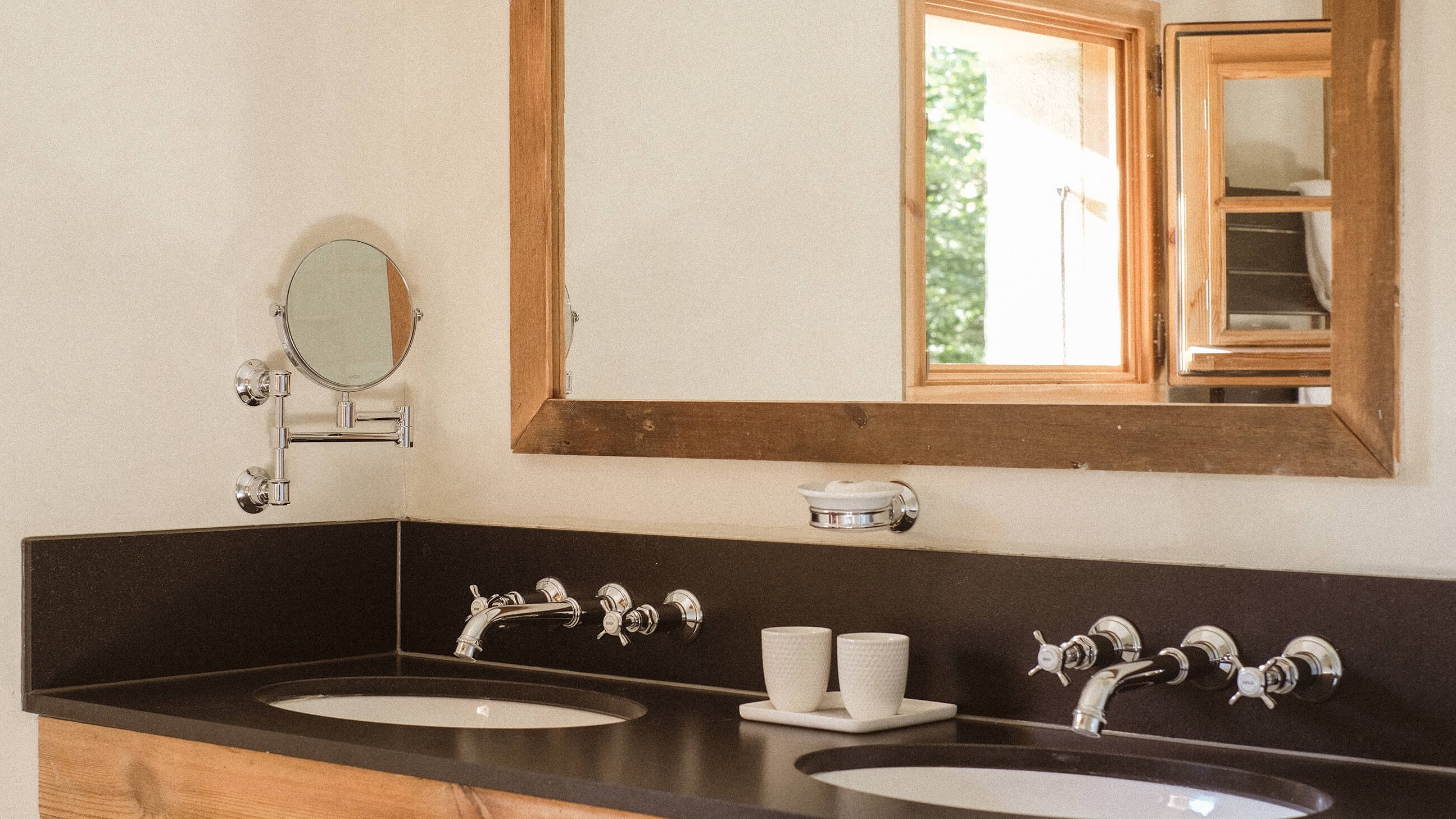 Bathroom with double sink, mirror, and chrome fixtures