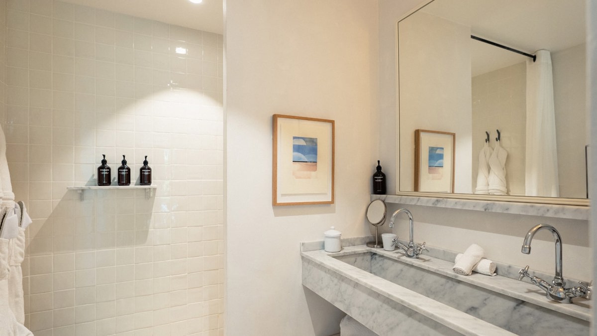A photo captures a modern bathroom, with all essentials neatly arranged and properly placed throughout.