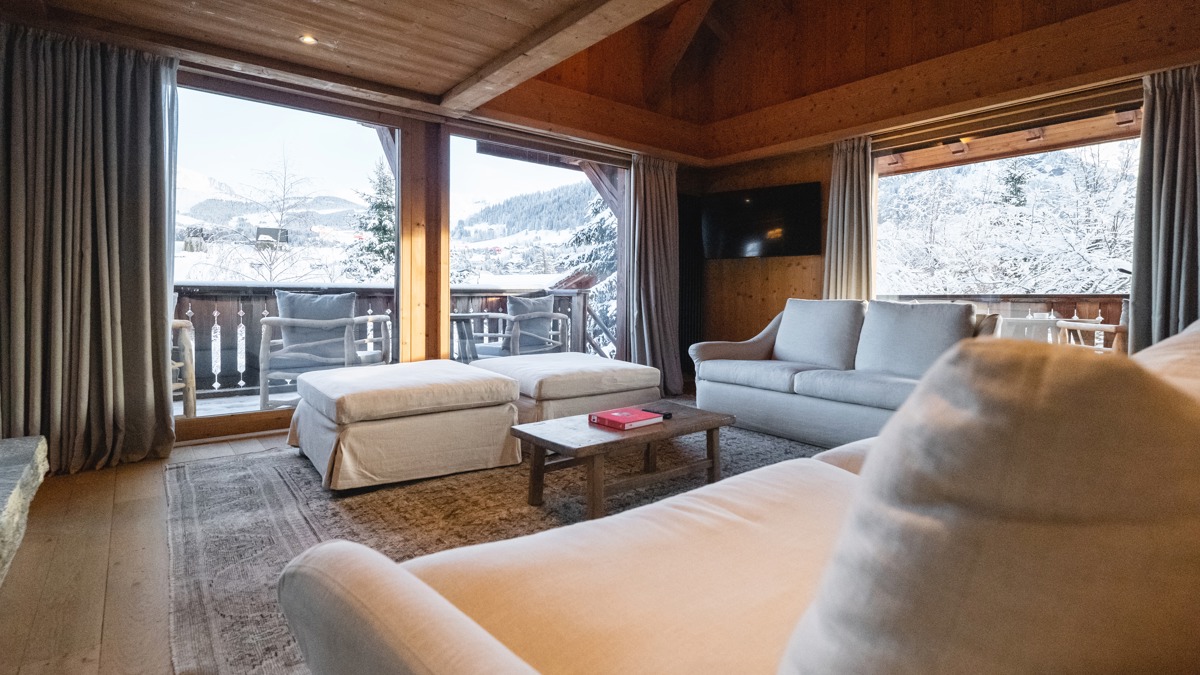 A clicked photo shows a living space with a cozy sofa set and snowy view outside.
