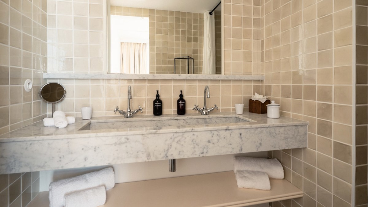 A photo captures a bathroom where bathing essentials are neatly arranged and properly organized throughout.