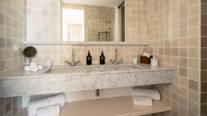 A photo captures a bathroom where bathing essentials are neatly arranged and properly organized throughout.