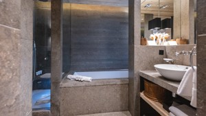 Luxury bathroom with stone bathtub and modern sink