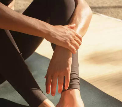 Person sitting on a yoga mat resting after a workout at Capelongue, Provence.