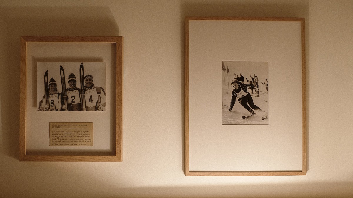 Two portraits are mounted on the white-finished wall, adding a touch of elegance.