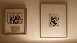 Two portraits are mounted on the white-finished wall, adding a touch of elegance.