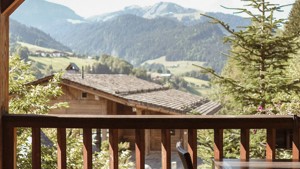 A wonderful view of lush green mountains can be seen from the house corridor.