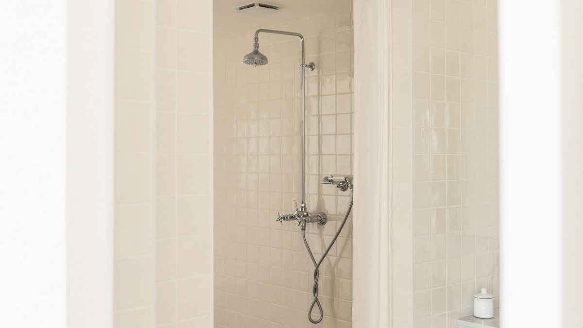 A photo captures a fitted shower installed neatly in the bathroom.